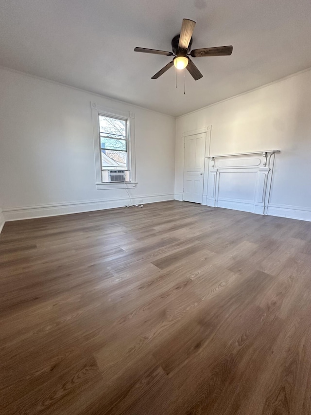 unfurnished room featuring cooling unit, baseboards, ceiling fan, and dark wood-style flooring