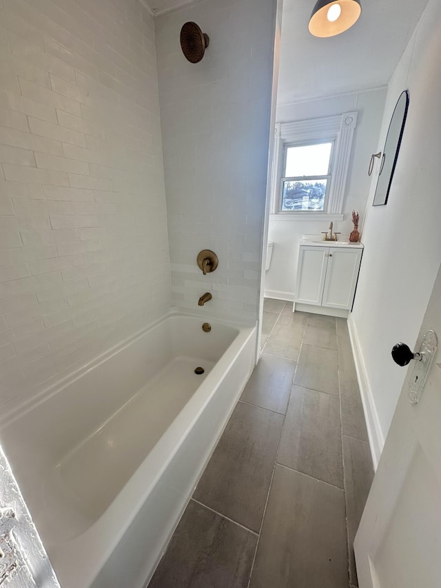 full bath with tile patterned flooring, bathtub / shower combination, vanity, and baseboards