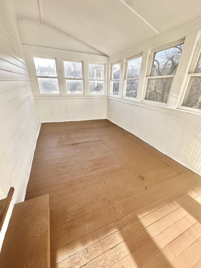 unfurnished sunroom with lofted ceiling