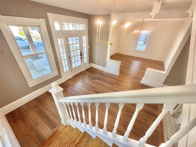 stairway featuring baseboards and wood finished floors