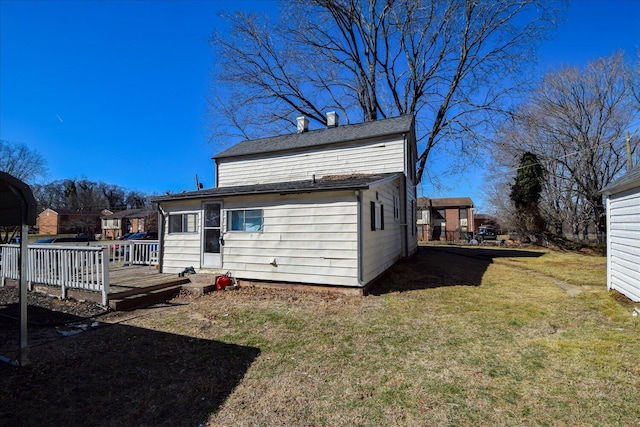 back of house with a lawn and a wooden deck