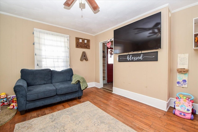 living room featuring ornamental molding, hardwood / wood-style floors, and ceiling fan