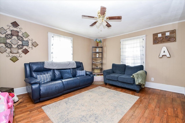 living room featuring hardwood / wood-style flooring, ornamental molding, and ceiling fan