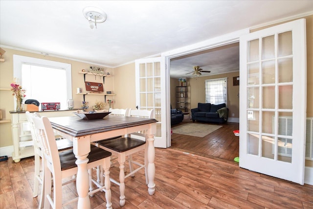 dining space with hardwood / wood-style flooring, ceiling fan, and ornamental molding