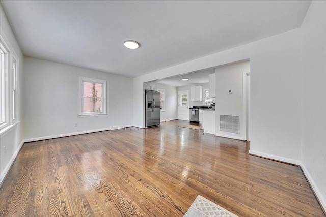 unfurnished living room with dark hardwood / wood-style floors