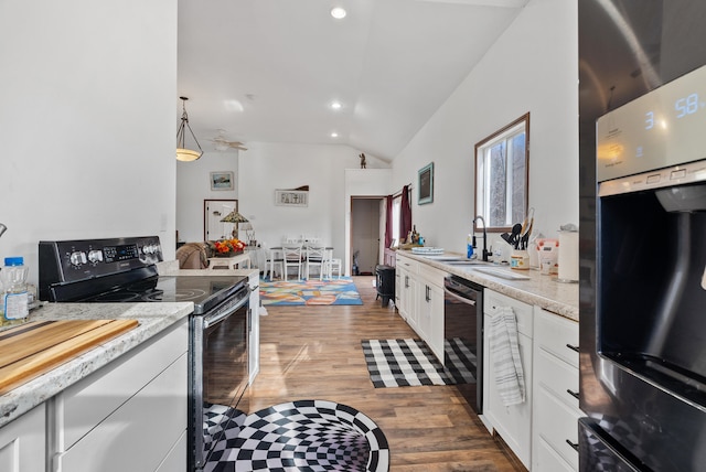 kitchen with black electric range oven, sink, dishwasher, white cabinetry, and oven