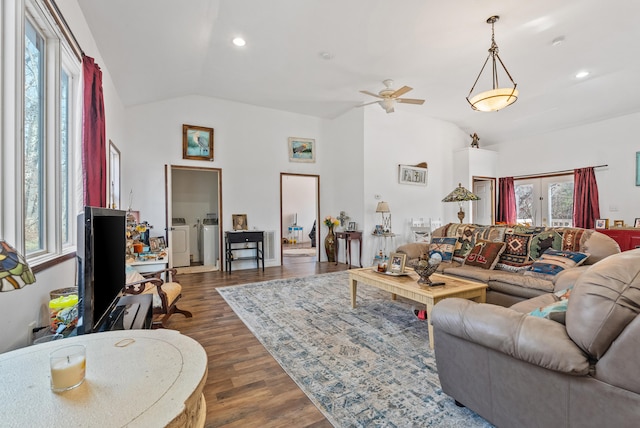 living room with lofted ceiling, ceiling fan, washing machine and dryer, dark hardwood / wood-style flooring, and french doors