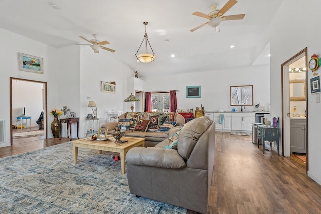 living room featuring sink, dark wood-type flooring, high vaulted ceiling, and ceiling fan