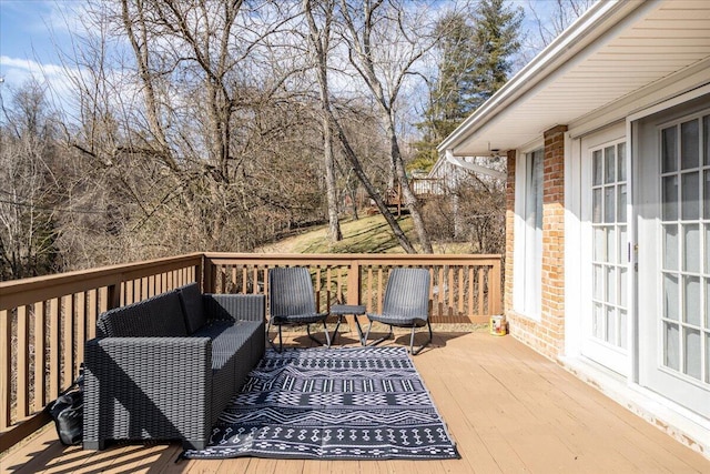 wooden terrace with outdoor lounge area