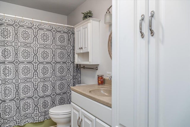 bathroom featuring vanity, toilet, and walk in shower