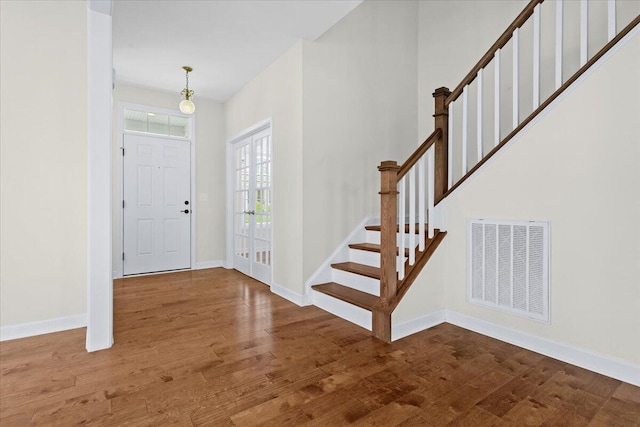 entrance foyer with french doors and wood-type flooring