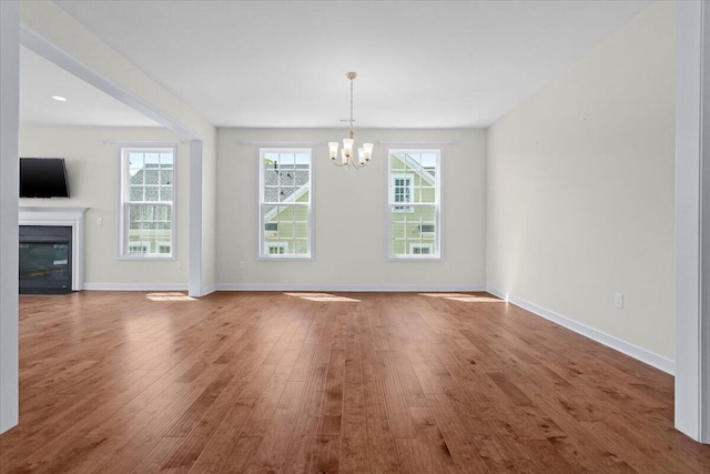 interior space featuring hardwood / wood-style floors and a notable chandelier