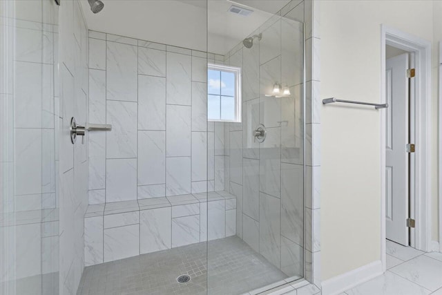 bathroom featuring a shower with shower door