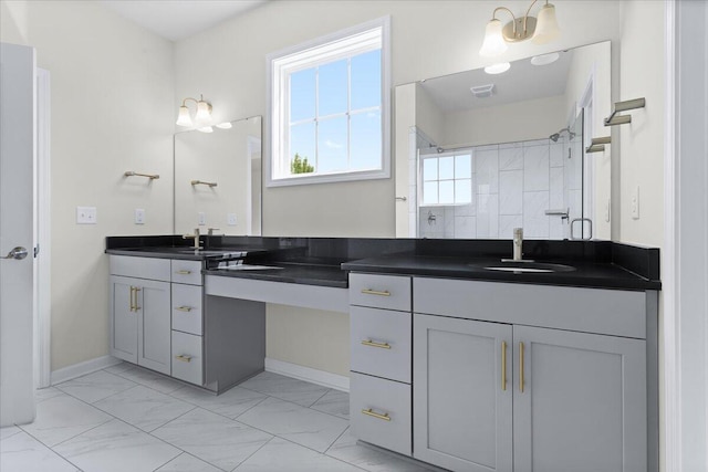 bathroom featuring a tile shower and vanity