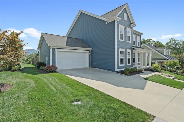 view of front of property with a garage and a front yard