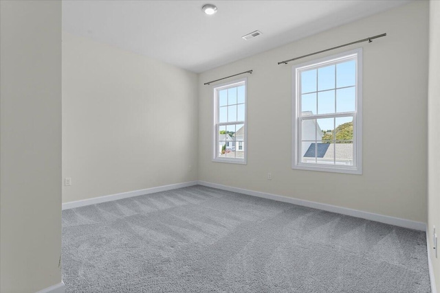 unfurnished room with light carpet