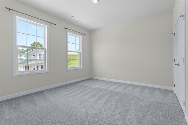 empty room featuring light carpet