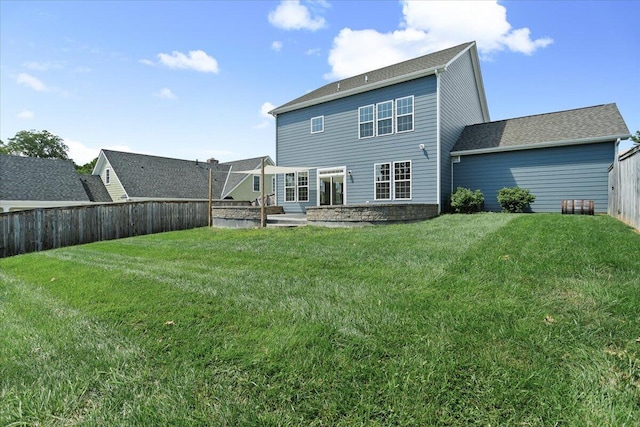 rear view of property featuring a yard