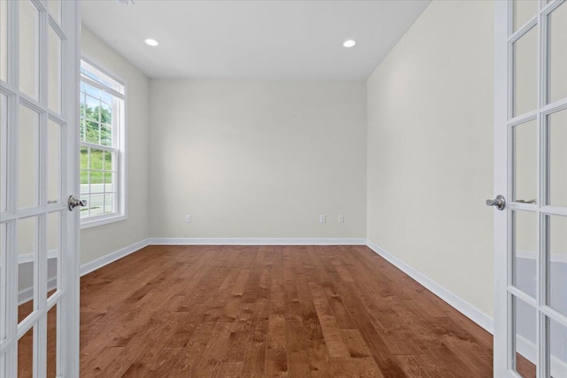 unfurnished room featuring hardwood / wood-style flooring and french doors