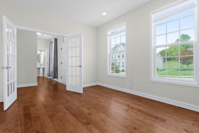 unfurnished room with french doors and dark wood-type flooring