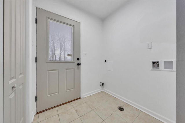 washroom with electric dryer hookup, light tile patterned floors, and hookup for a washing machine