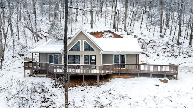 snow covered house with a deck