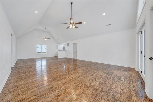 unfurnished living room with high vaulted ceiling, hardwood / wood-style floors, and ceiling fan