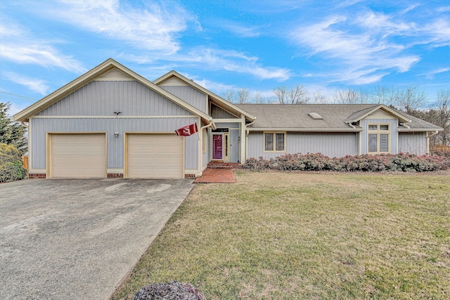 view of front of home featuring a garage, driveway, and a front yard