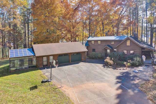 log cabin featuring an outbuilding, a front yard, and solar panels