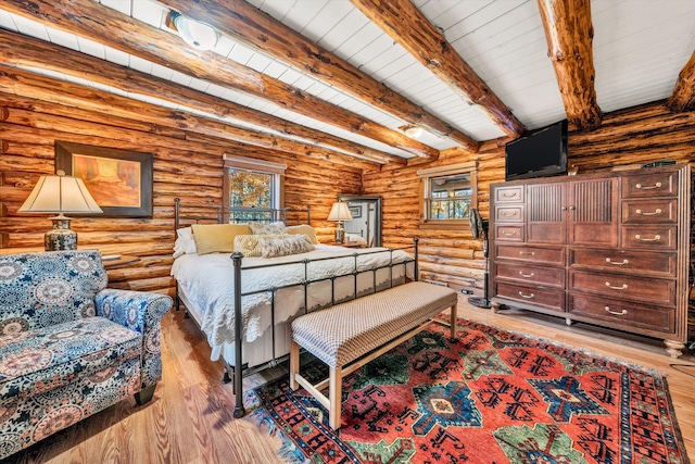bedroom with beam ceiling, light hardwood / wood-style flooring, and wooden ceiling