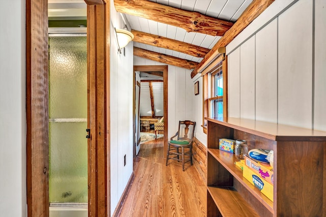 hall featuring lofted ceiling with beams, wood ceiling, and light wood-type flooring