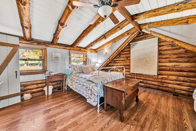 bedroom featuring hardwood / wood-style flooring, lofted ceiling with beams, wooden ceiling, and rustic walls