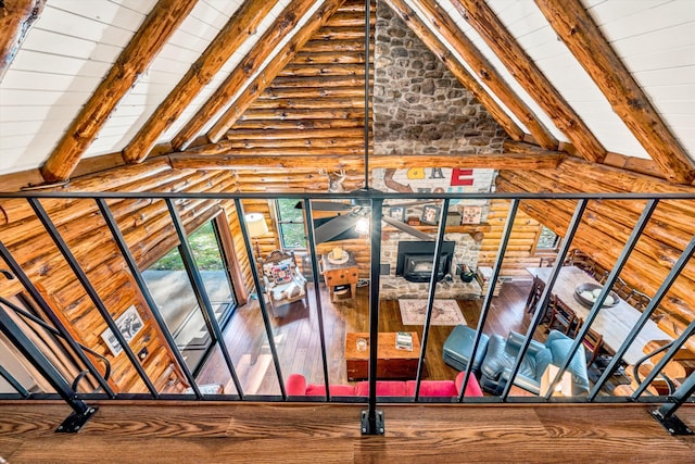 interior space featuring wood ceiling, log walls, beam ceiling, and high vaulted ceiling