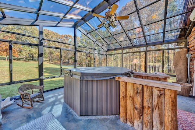 view of patio featuring a hot tub, exterior bar, and ceiling fan