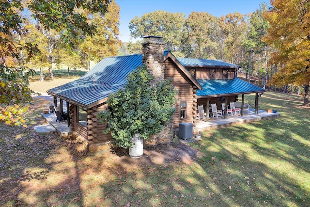 view of property exterior with a yard, central AC, and a patio area