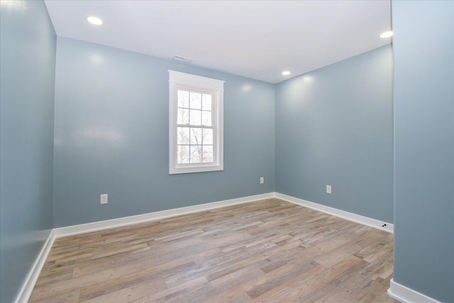 spare room with visible vents, wood finished floors, baseboards, and recessed lighting