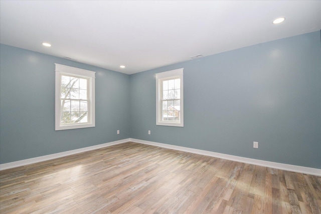 spare room with light wood-style floors, recessed lighting, and baseboards