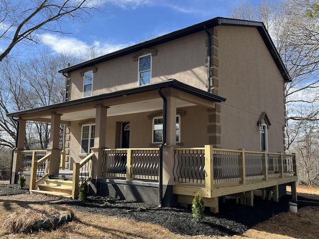 exterior space with covered porch and stucco siding