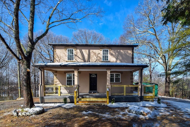 view of front of home with covered porch and stucco siding