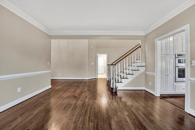 foyer entrance featuring ornamental molding and dark hardwood / wood-style flooring