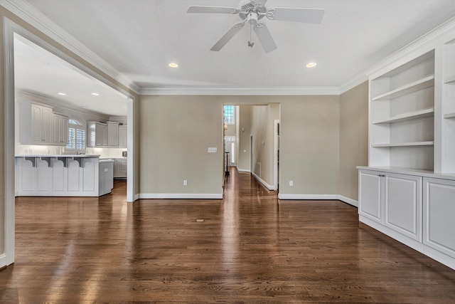 unfurnished living room with crown molding, dark hardwood / wood-style floors, built in features, and ceiling fan