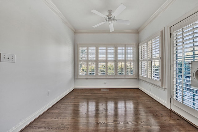 empty room with dark hardwood / wood-style flooring, ornamental molding, and ceiling fan