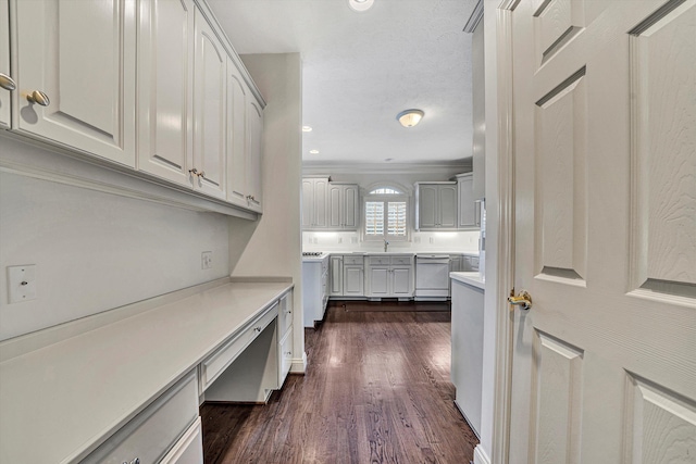 interior space featuring washer and dryer, crown molding, dark hardwood / wood-style floors, and a textured ceiling