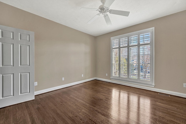 unfurnished room featuring a textured ceiling, dark wood-type flooring, and ceiling fan