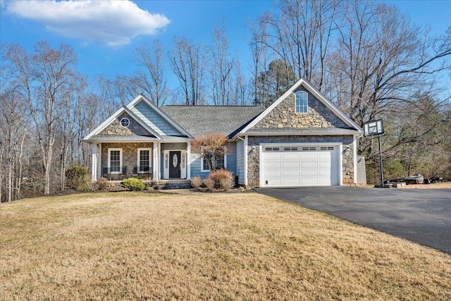 craftsman-style house featuring a garage, a front lawn, and a porch