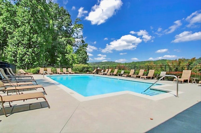 view of pool featuring a patio and a mountain view