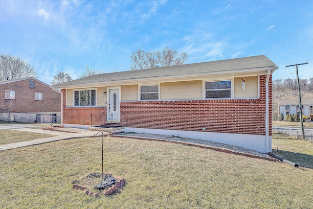 view of front facade with brick siding and a front lawn