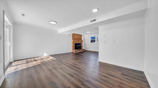 unfurnished living room with dark wood-style floors, a brick fireplace, visible vents, and baseboards