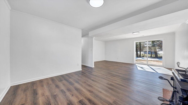 interior space featuring baseboards and dark wood-type flooring