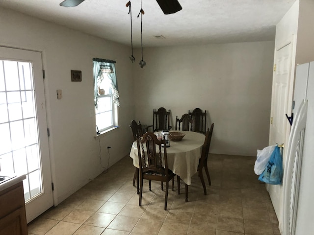 dining area with ceiling fan and light tile patterned floors